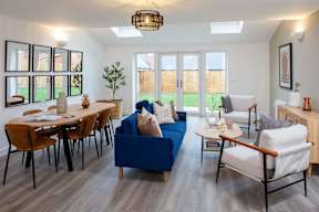 A living room with a blue couch and a wooden table.