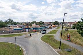 A road with a curve leading to a construction site.