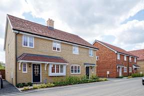 A row of houses with a car parked in front.