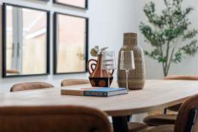 A table with a book titled Kinfolk Islands and two bottles on it.