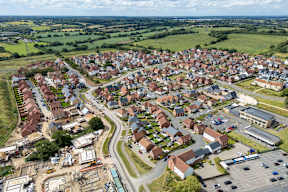 A small town with a lot of houses and a parking lot.