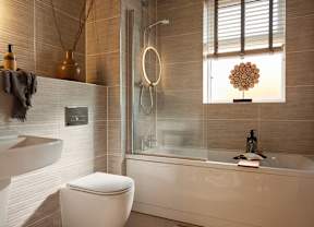 A modern bathroom with a white toilet, a white bathtub, and a glass shower.
