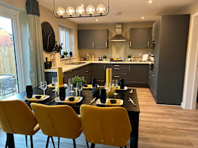 A modern kitchen with a dining table set for four.