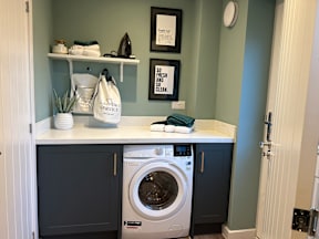A small laundry room with a washer and dryer.