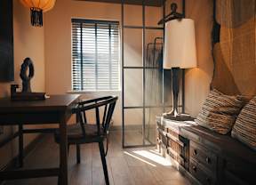 A room with a wooden table and a chair.