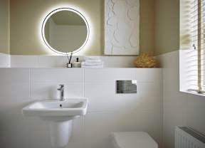 A bathroom with a white sink and toilet.