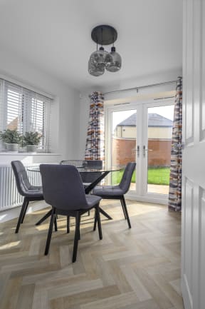 a dining room with a table and chairs
