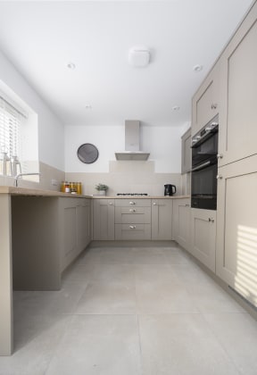 a large kitchen with white cabinets and a counter top