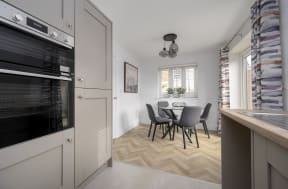 a kitchen and dining room with a table and chairs