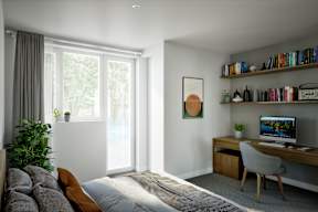 A modern bedroom with a large bed and a desk with a computer.