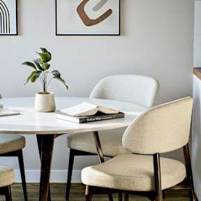 A white table with a plant and a book on it.