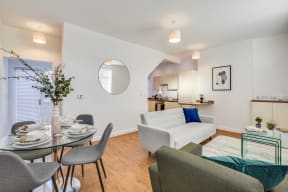 a living room and dining room with a table and chairs