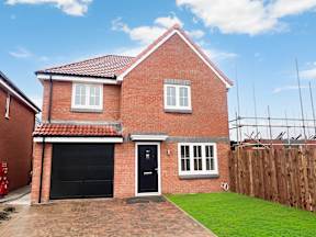 A red brick house with a black door and windows.