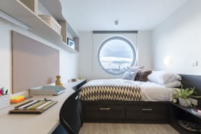 a bedroom with a bed and a window