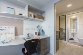 a home office with a desk and a mirror