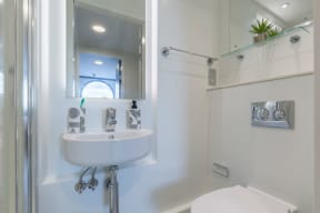 a small bathroom with a sink and a shower
