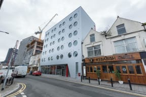a building with a facade that has circles on it