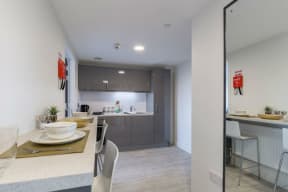 a kitchen and dining area with a table and chairs