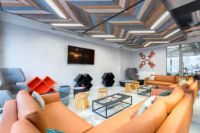 a living room with couches and chairs and a tv