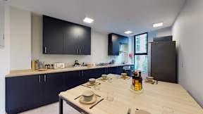 A kitchen with a table set for a meal.