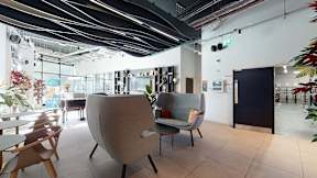 A modern office space with a large chair in the center.