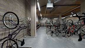 A bike rack with many bicycles parked.