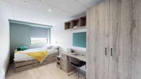 a bedroom with a bed and a desk
