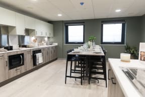 an open kitchen and dining area with a table and chairs