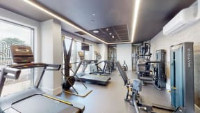 a gym with various machines and weights in a room with a window