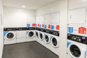 a row of washing machines in a laundry room