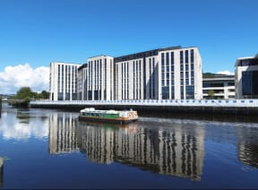 a boat on the water in front of a building