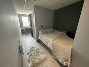 a bedroom with a bed in a small room
