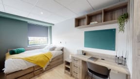 a bedroom with a bed and a desk