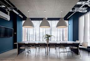 A conference room with a long table and chairs.