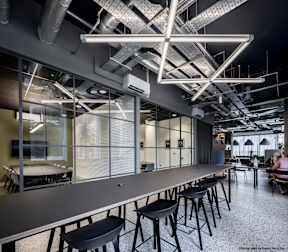 A modern conference room with a long table and chairs.