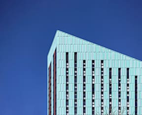 A tall building with a blue sky in the background.