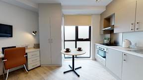 A modern kitchen with a table and chairs.