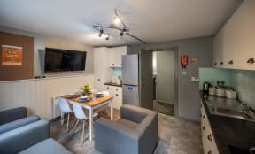a kitchen and dining area with a table and chairs