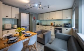 a living room and kitchen with a dining table and chairs