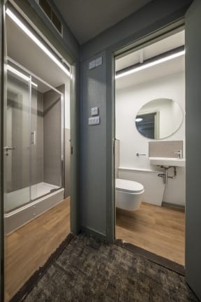 a bathroom with a toilet and a sink and a shower