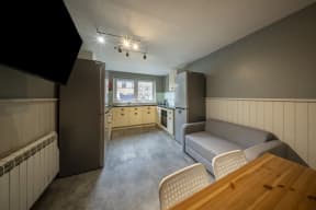 a kitchen and living room with a table and a couch