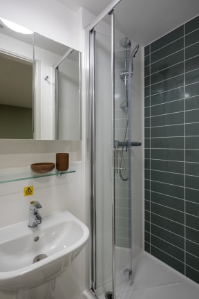a small bathroom with a shower and a sink
