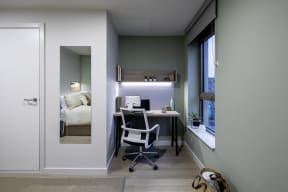 a home office with a desk and a window