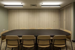 a conference room with a long table and chairs