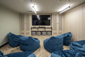 a room with blue pillows and a television on the wall