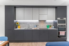 a kitchen with gray cabinets and a sink