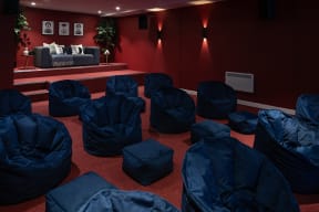 a room filled with chairs covered in blue sleeping bags