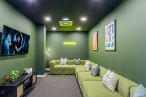 a living room with green walls and yellow couches
