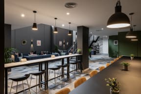 the lobby of a restaurant with a bar and chairs