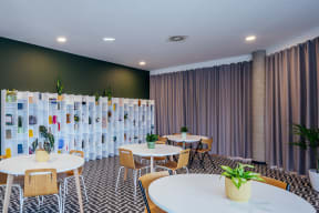 a room with tables and chairs and a wall with a partition